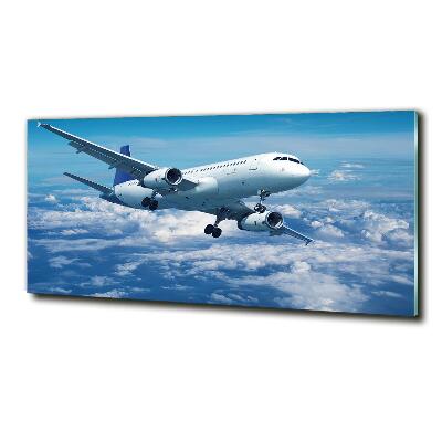 Foto schilderij op glas Een vliegtuig in de wolken