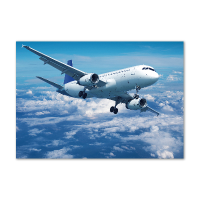 Foto schilderij op glas Een vliegtuig in de wolken