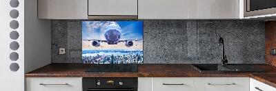 Keuken achterwand Een vliegtuig boven de stad