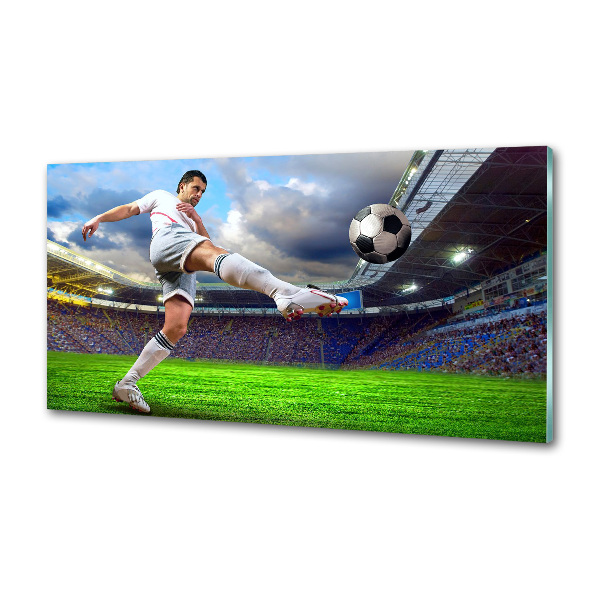 Glazen achterwand keuken Een voetballer in het stadion.