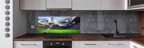 Glazen achterwand keuken Een voetballer in het stadion.