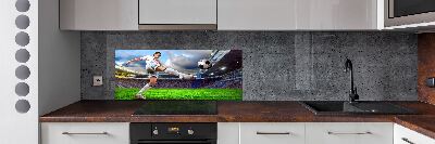 Glazen achterwand keuken Een voetballer in het stadion.