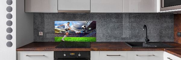 Glazen achterwand keuken Een voetballer in het stadion.