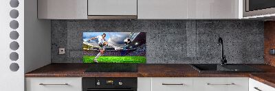 Glazen achterwand keuken Een voetballer in het stadion.