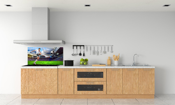 Glazen achterwand keuken Een voetballer in het stadion.