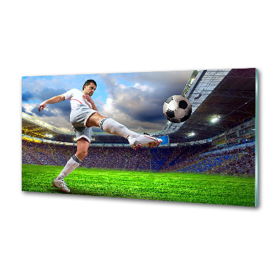 Glazen achterwand keuken Een voetballer in het stadion.