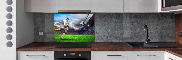 Glazen achterwand keuken Een voetballer in het stadion.