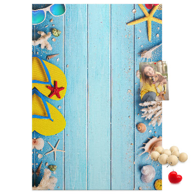Memobord van kurk met zomerse strandaccessoires op een blauwe achtergrond