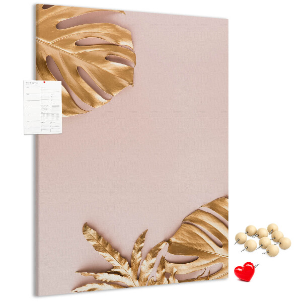 Memobord van kurk met gouden blaadjes op een zachtroze achtergrond