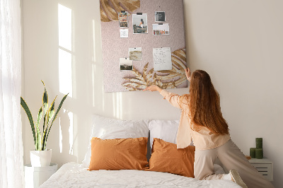 Memobord van kurk met gouden blaadjes op een zachtroze achtergrond