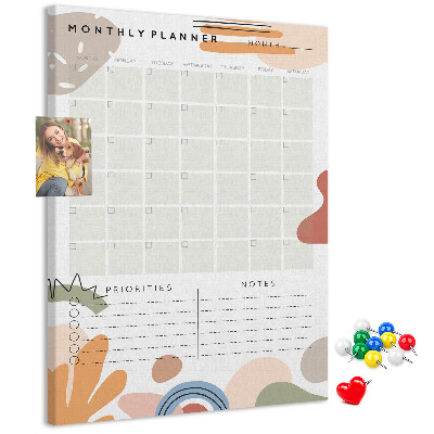 Kurken memobord maandplanner met kleurrijke abstracte vormen