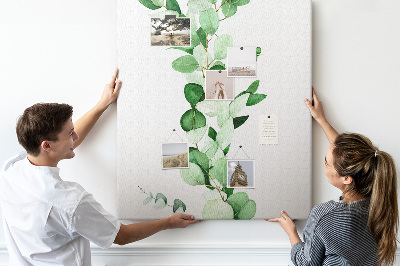 Kurken memobord met groene bladeren op een lichte achtergrond