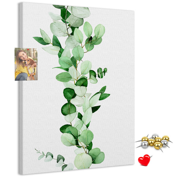 Kurken memobord met groene bladeren op een lichte achtergrond