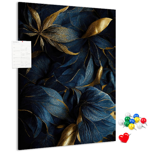 Prikbord van kurk met print van gouden bladeren op een donkere achtergrond