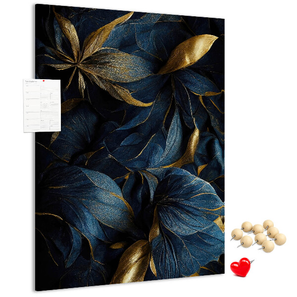 Prikbord van kurk met print van gouden bladeren op een donkere achtergrond