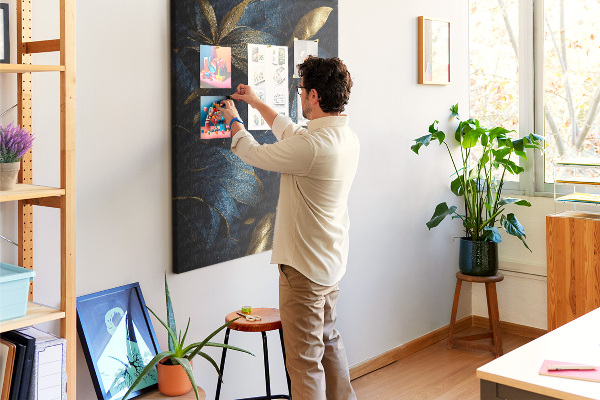 Prikbord van kurk met print van gouden bladeren op een donkere achtergrond