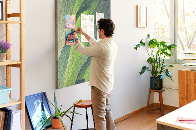 Memobord van kurk met een motief van groene bladeren in subtiele tinten