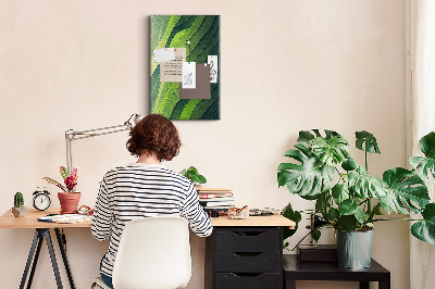 Memobord van kurk met een motief van groene bladeren in subtiele tinten