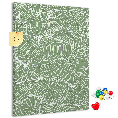 Memobord van kurk met fijne blaadjes op een groene achtergrond