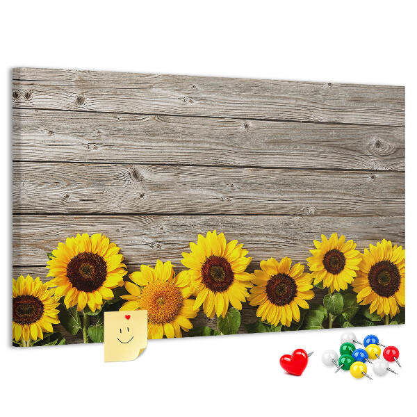 Kurkbord met een afbeelding van zonnebloemen op een achtergrond van houten planken