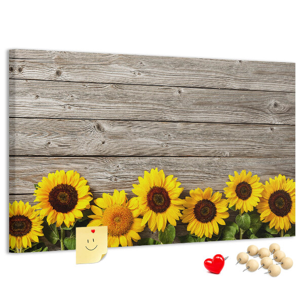 Kurkbord met een afbeelding van zonnebloemen op een achtergrond van houten planken