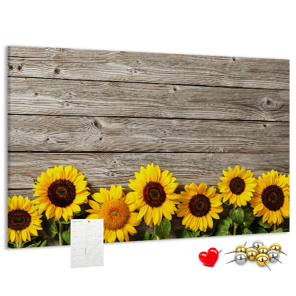 Kurkbord met een afbeelding van zonnebloemen op een achtergrond van houten planken