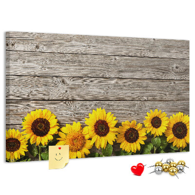 Kurkbord met een afbeelding van zonnebloemen op een achtergrond van houten planken