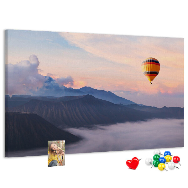 Prikbord met een ballon tegen een berglandschap bij zonsopgang