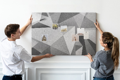 Prikbord met abstracte grijze en zwarte geometrische vormen