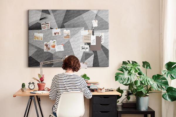 Prikbord met abstracte grijze en zwarte geometrische vormen