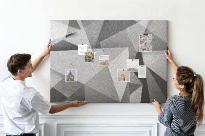Prikbord met abstracte grijze en zwarte geometrische vormen