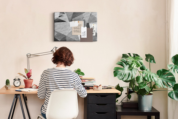 Prikbord met abstracte grijze en zwarte geometrische vormen