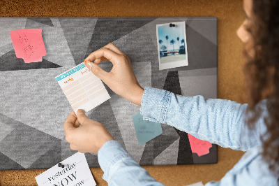 Prikbord met abstracte grijze en zwarte geometrische vormen