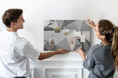 Prikbord met abstracte grijze en zwarte geometrische vormen