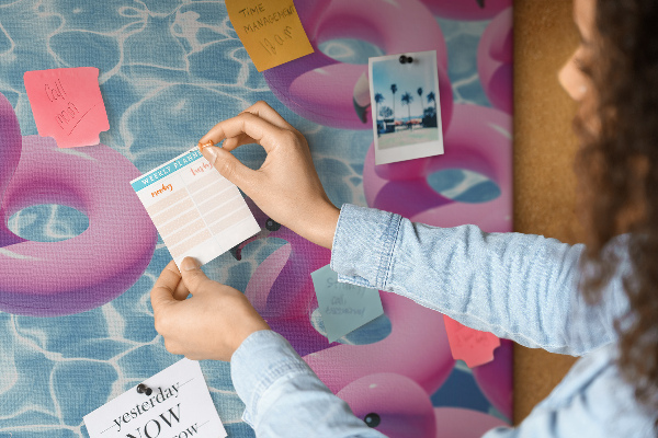 Prikbord met afbeelding van roze flamingo's tegen blauw water