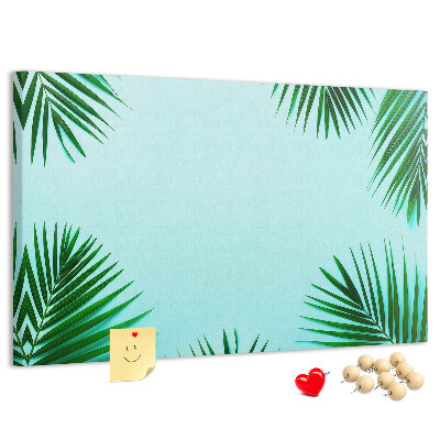 Prikbord met tropische bladeren op een blauwe achtergrond