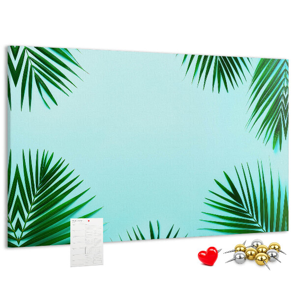 Prikbord met tropische bladeren op een blauwe achtergrond