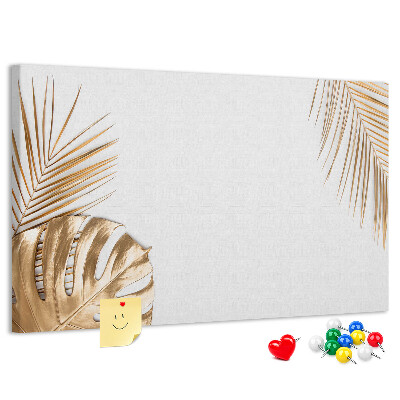 Prikbord met gouden bladeren op een witte achtergrond