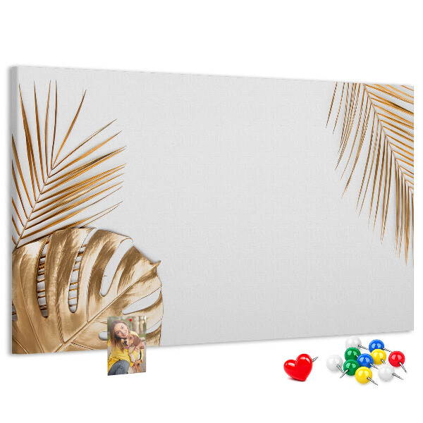 Prikbord met gouden bladeren op een witte achtergrond