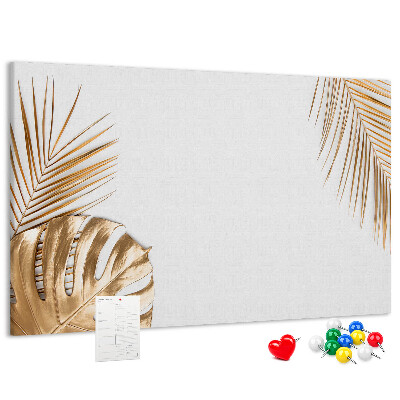 Prikbord met gouden bladeren op een witte achtergrond