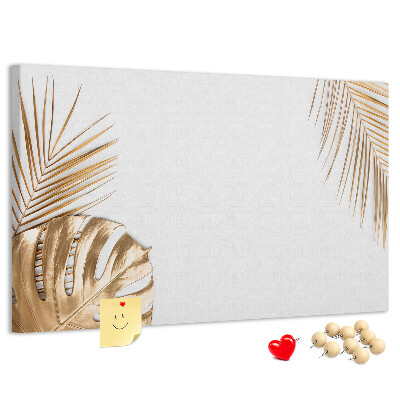 Prikbord met gouden bladeren op een witte achtergrond