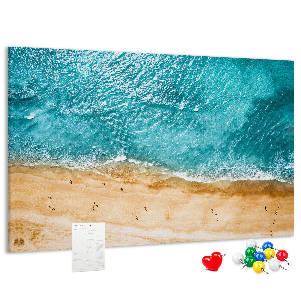 Kurkbord met een afbeelding van een strand met golven en voetsporen
