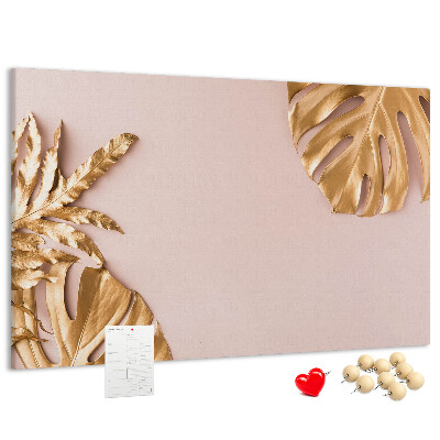 Prikbord met gouden bladeren op een delicate achtergrond