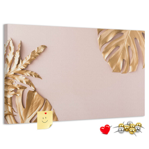 Prikbord met gouden bladeren op een delicate achtergrond