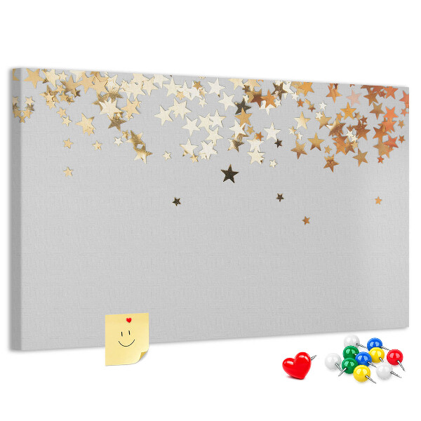 Kurkbord met gouden sterren op een grijze achtergrond