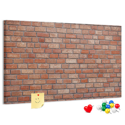 Prikbord met print van een bakstenen muur in warme tinten