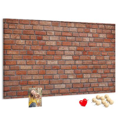 Prikbord met print van een bakstenen muur in warme tinten