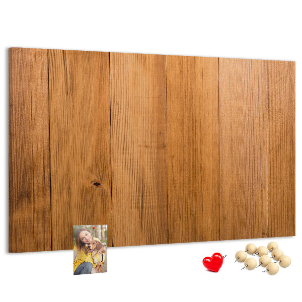 Prikbord van hout met gekleurde pinnen