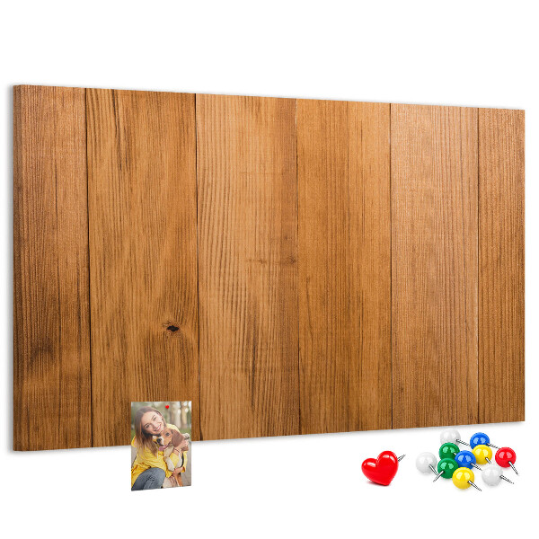 Prikbord van hout met gekleurde pinnen