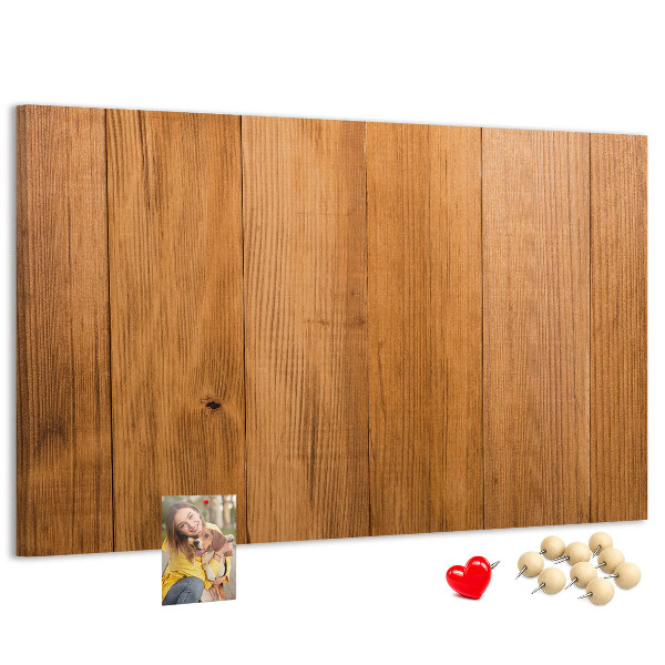 Prikbord van hout met gekleurde pinnen